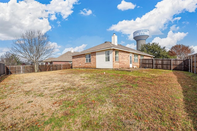 rear view of house with a lawn