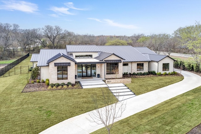 modern farmhouse style home featuring a front lawn