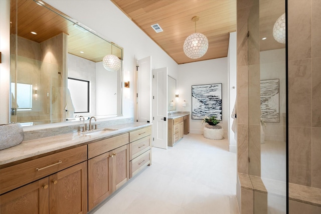 bathroom with wood ceiling, vanity, and a tile shower