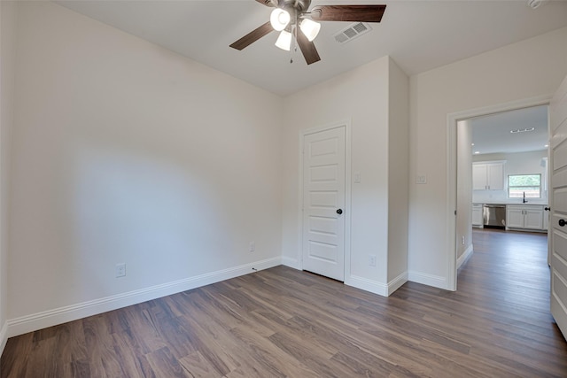 empty room with hardwood / wood-style flooring and ceiling fan