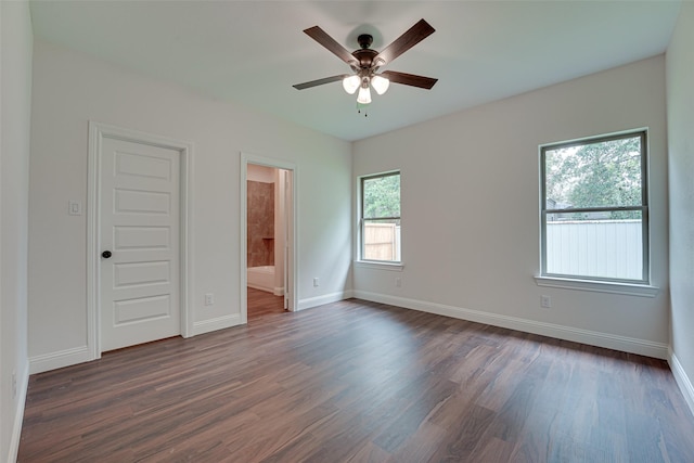 unfurnished room featuring dark wood-type flooring and ceiling fan