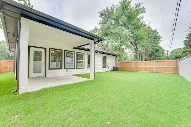 view of yard with central AC and a patio area