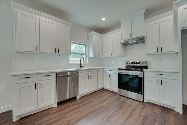 kitchen featuring sink, dark wood-type flooring, appliances with stainless steel finishes, backsplash, and white cabinets