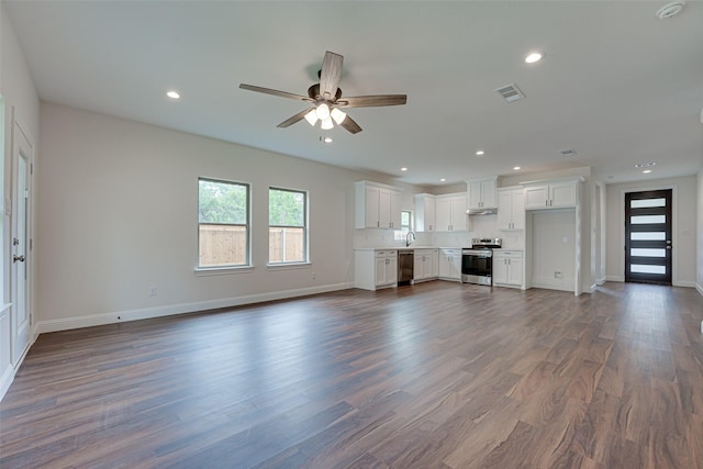 unfurnished living room featuring ceiling fan, dark hardwood / wood-style flooring, and sink