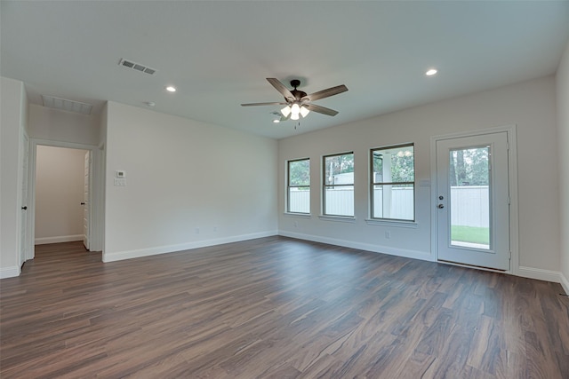 spare room featuring dark wood-type flooring and ceiling fan