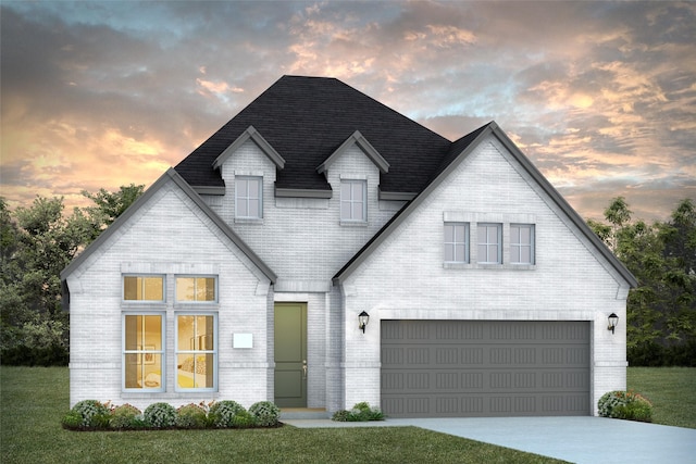 view of front of property featuring a garage and a yard