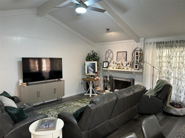 living room featuring hardwood / wood-style flooring, a fireplace, lofted ceiling with beams, and a textured ceiling