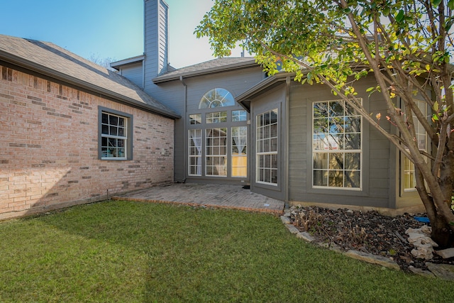 rear view of property with a patio and a yard