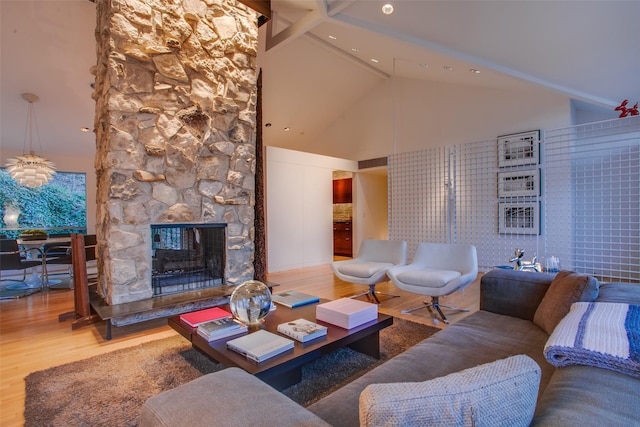 living room with wood-type flooring, a fireplace, high vaulted ceiling, and beam ceiling