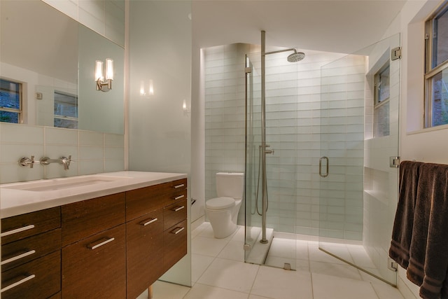 bathroom featuring a shower with door, tile patterned flooring, vanity, decorative backsplash, and toilet