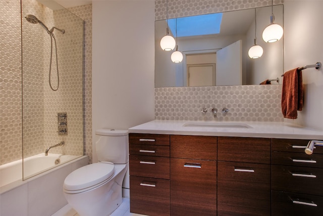 full bathroom featuring bath / shower combo with glass door, vanity, backsplash, and toilet