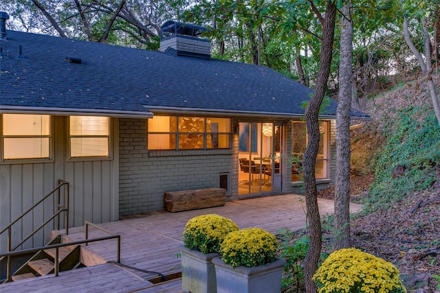 rear view of property with a wooden deck