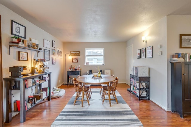 dining space featuring wood-type flooring