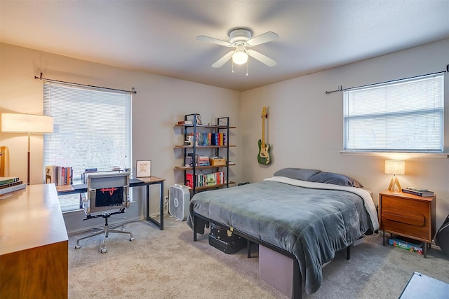 bedroom featuring ceiling fan and light carpet