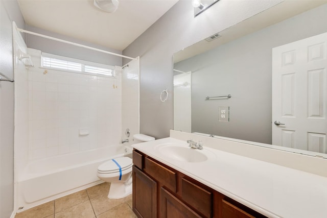 full bathroom with tiled shower / bath, vanity, toilet, and tile patterned flooring