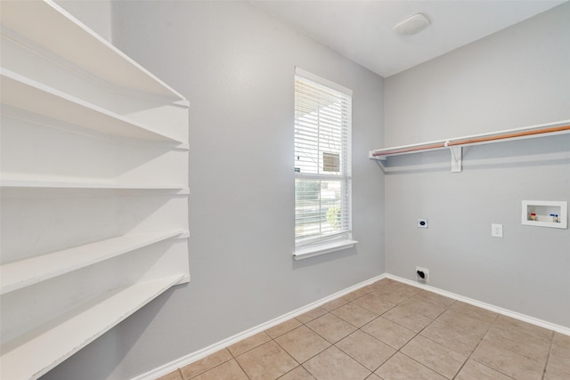 laundry area featuring electric dryer hookup, washer hookup, and light tile patterned floors