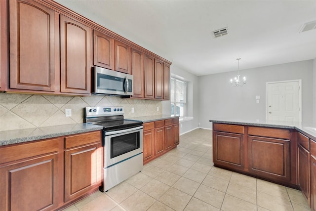 kitchen featuring appliances with stainless steel finishes, pendant lighting, tasteful backsplash, a notable chandelier, and light stone counters