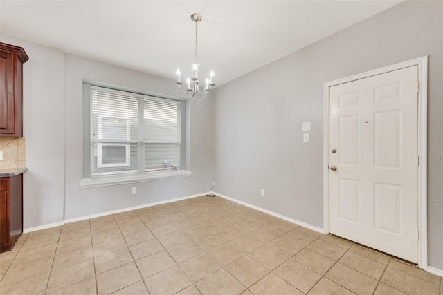 unfurnished dining area with light tile patterned floors and an inviting chandelier