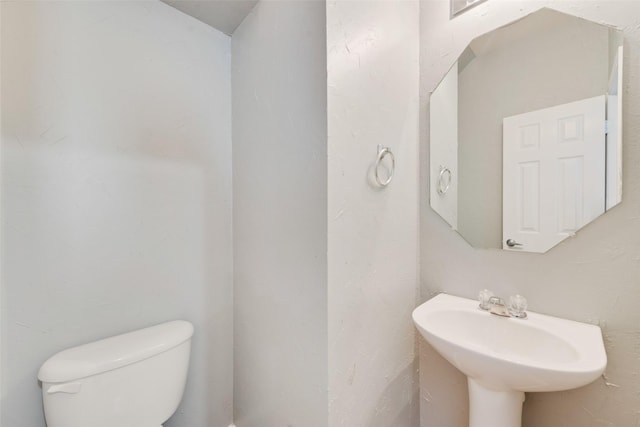 bathroom featuring sink and toilet