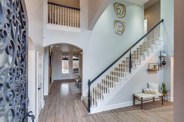 entryway featuring light hardwood / wood-style flooring and a high ceiling