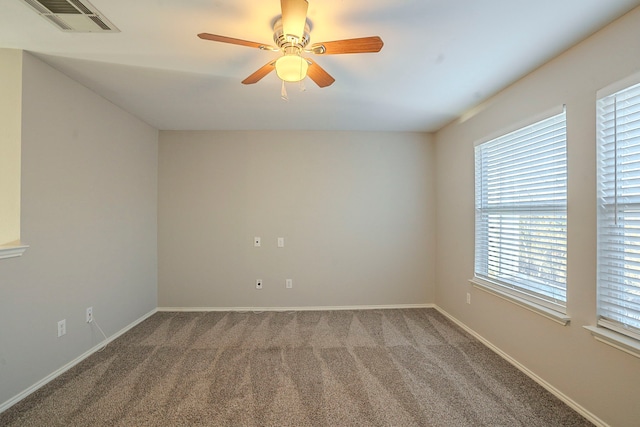 spare room featuring ceiling fan and carpet flooring