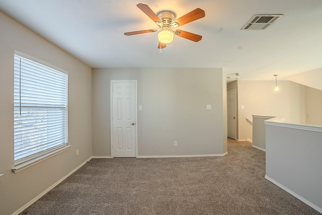 spare room featuring carpet and ceiling fan