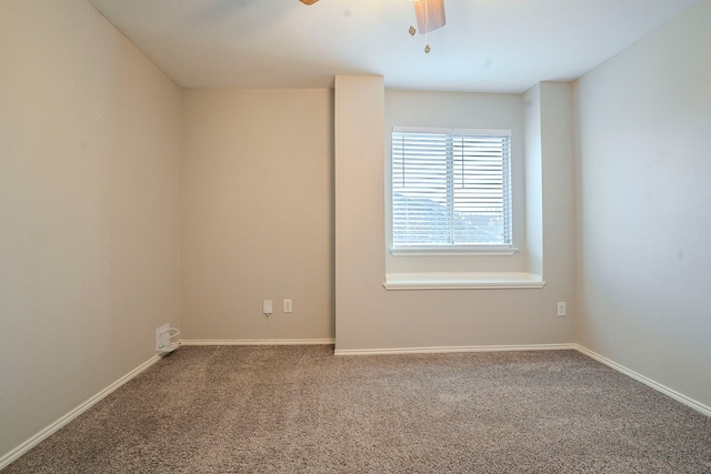 carpeted spare room featuring ceiling fan