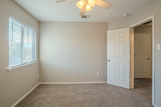 carpeted empty room featuring ceiling fan