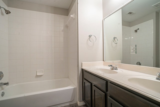 bathroom with vanity and tiled shower / bath combo