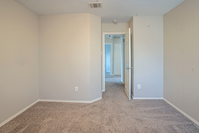 empty room featuring light carpet