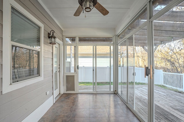 unfurnished sunroom with ceiling fan