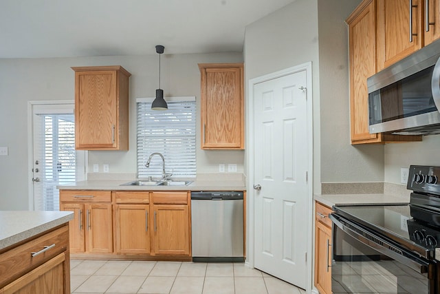 kitchen with stainless steel appliances, sink, hanging light fixtures, and light tile patterned floors