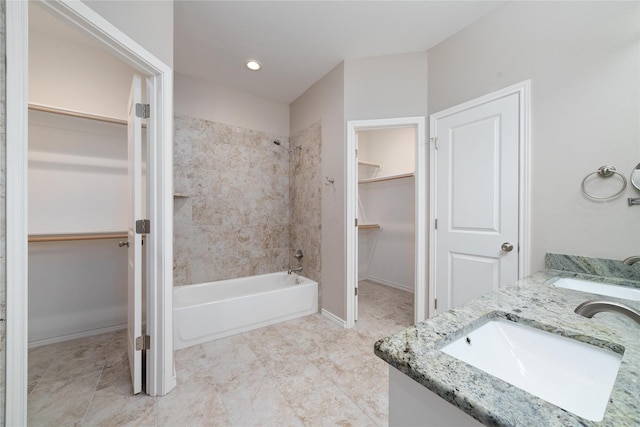 bathroom with vanity and tiled shower / bath