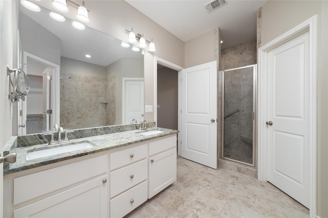 bathroom featuring vanity and a shower with shower door