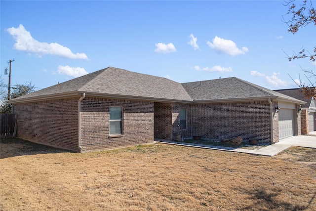 view of front of property with a garage and a front lawn