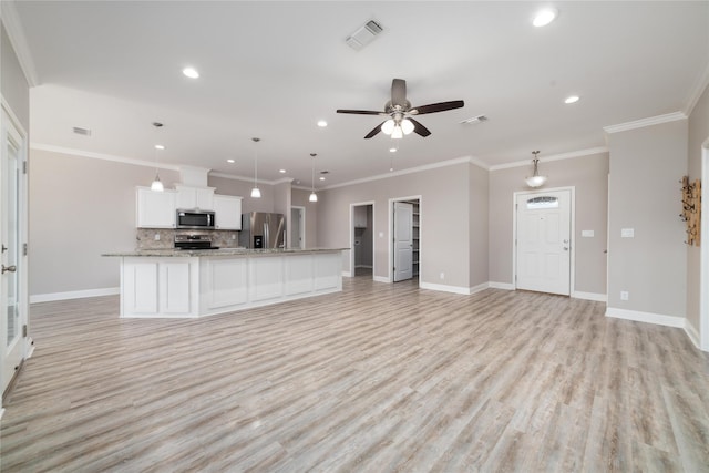 unfurnished living room with ceiling fan, ornamental molding, and light hardwood / wood-style flooring