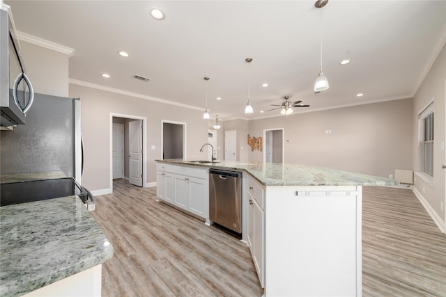 kitchen featuring pendant lighting, white cabinetry, a center island with sink, and appliances with stainless steel finishes