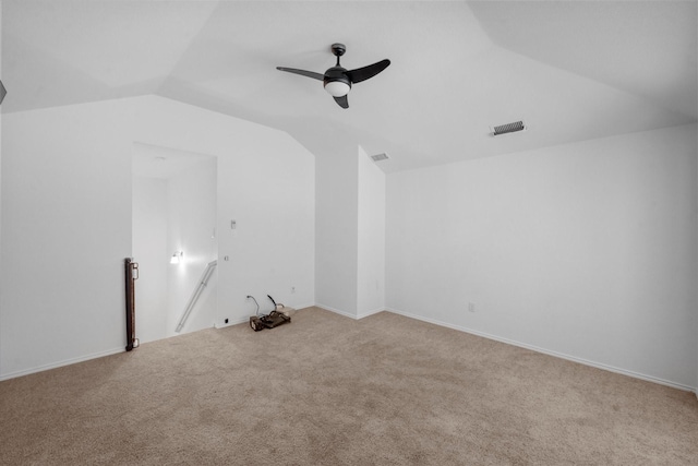 interior space featuring lofted ceiling, light carpet, and ceiling fan