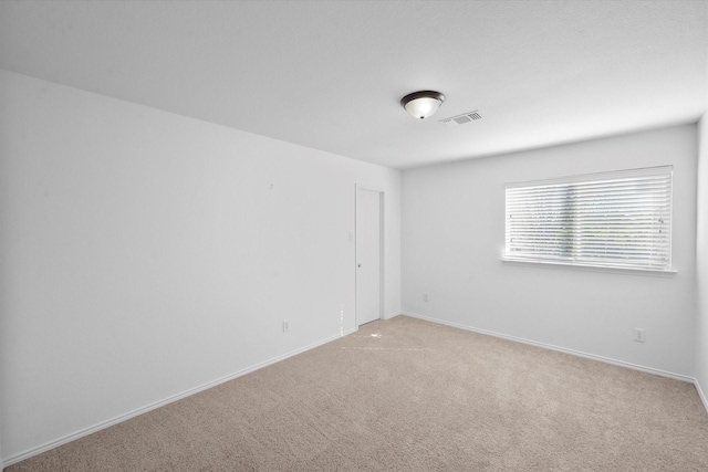 empty room featuring light carpet