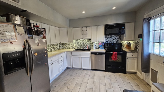 833 James St, Azle, TX 76020 - kitchen with black appliances, a sink, light countertops, white cabinets, and recessed lighting