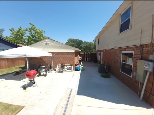 833 James St, Azle, TX 76020 - view of property exterior with a patio, central AC unit, brick siding, and fence