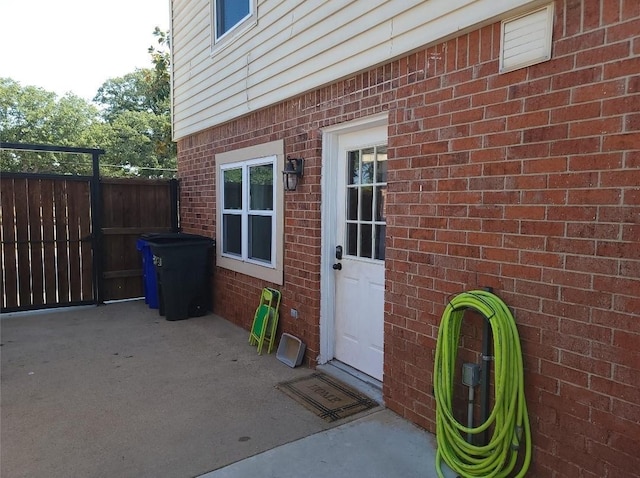 833 James St, Azle, TX 76020 - view of exterior entry featuring brick siding and fence