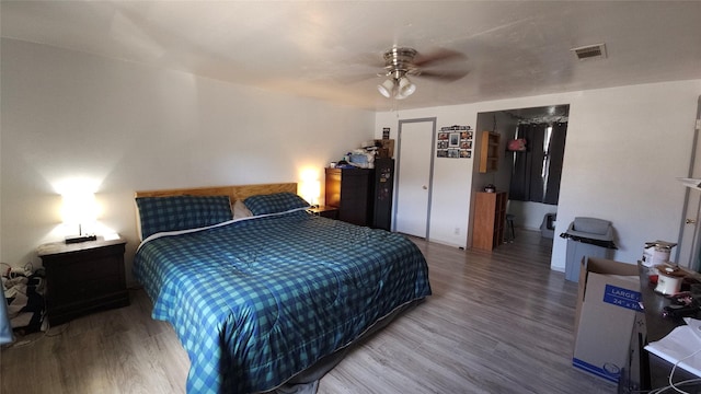 bedroom featuring hardwood / wood-style flooring and ceiling fan