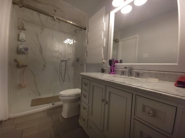 833 James St, Azle, TX 76020 - bathroom featuring a marble finish shower, vanity, toilet, and tile patterned flooring