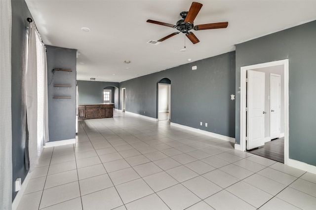 unfurnished living room featuring ceiling fan and light tile patterned floors