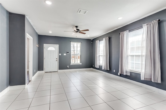 foyer with light tile patterned floors and ceiling fan