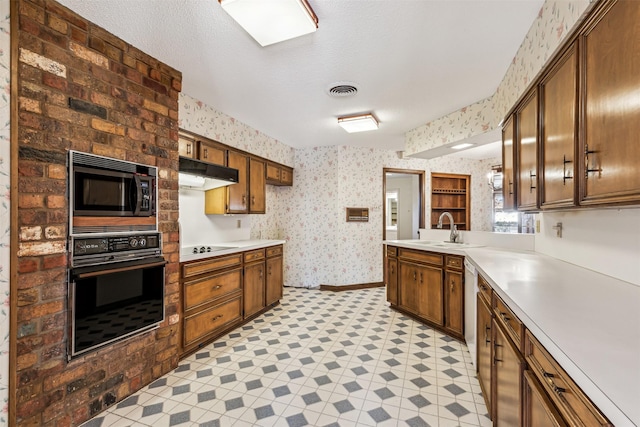 kitchen featuring sink, a textured ceiling, and black appliances