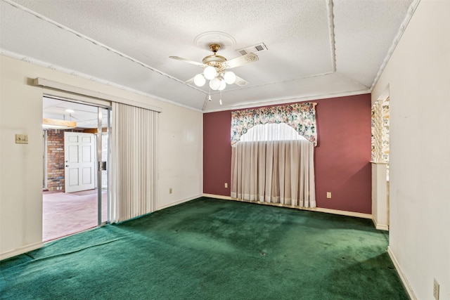 carpeted empty room featuring ceiling fan, crown molding, and a textured ceiling