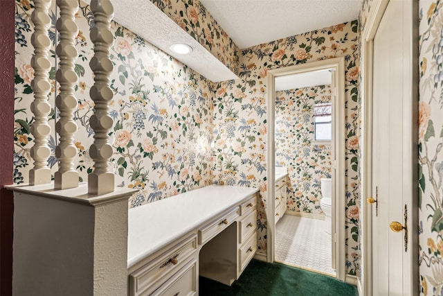 bathroom featuring a textured ceiling and toilet