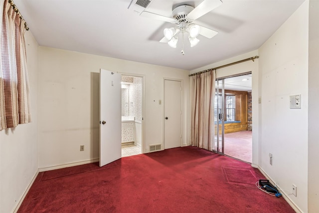 unfurnished bedroom with ceiling fan, light colored carpet, and ensuite bath